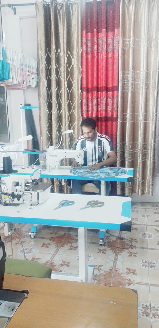 Modern tailor workshop with sewing machine and fabric rolls in natural daylight